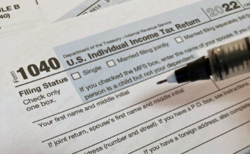 Filing taxes doesn’t have to be complicated, professors say A pen hovering over a Form 1040, U.S. Individual Income Tax Return