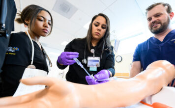 Nurses are becoming more scarce. Here’s how SLCC is preparing them for success Nursing student Barbara, center, learning intravenous applications