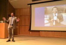 SLCC’s semi-annual Student Speakers’ Showcase returns Mats Mudrow gives a presentation next to a projection screen with his likeness on it