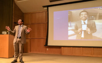SLCC’s semi-annual Student Speakers’ Showcase returns Mats Mudrow gives a presentation next to a projection screen with his likeness on it