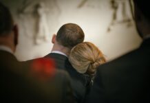 Students facing grief have access to support resources Woman resting head on man's shoulder during a service