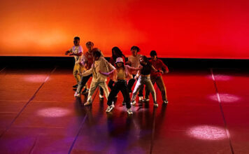 Dance students showcase their final work for ‘Body Language’ concert Eight dancers perform underneath red and orange lighting