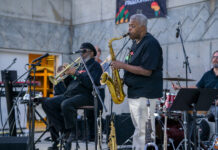Music shapes SLCC’s Juneteenth celebration Clifton Sanders standing in foreground and playing a saxophone