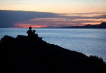 Water year leaves slightly fewer Utahns worried about Great Salt Lake Silhouette of two people viewing a sunset from an overlook