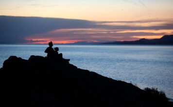 Water year leaves slightly fewer Utahns worried about Great Salt Lake Silhouette of two people viewing a sunset from an overlook