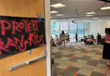 Push for ‘transgender’ court naming to continue despite roadblock at Pride picnic A hand-painted sign on the entry door to the Pride Picnic reads, "Protect Trans Kids"