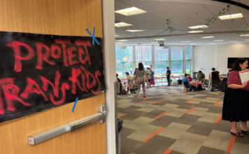 Push for ‘transgender’ court naming to continue despite roadblock at Pride picnic A hand-painted sign on the entry door to the Pride Picnic reads, "Protect Trans Kids"