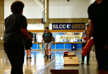 Trans Sports Ball Day serves as a space for all to exercise, have fun Several people playing cornhole in a gymnasium
