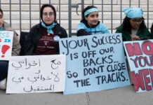 What does the end of affirmative action mean for higher ed? Young women sitting on ground holding signs in support of affirmative action