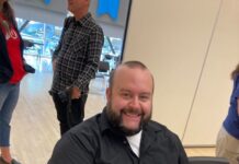 Letter from the editor: We are Bruins, hear us roar! Sean Stetson holding a camera while seated