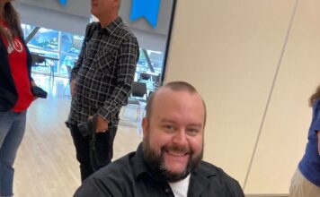 Letter from the editor: We are Bruins, hear us roar! Sean Stetson holding a camera while seated