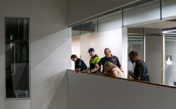 Recent campus walkabouts seek to rectify safety and accessibility issues Security officials looking down while explaining possible security improvements at Herriman Campus