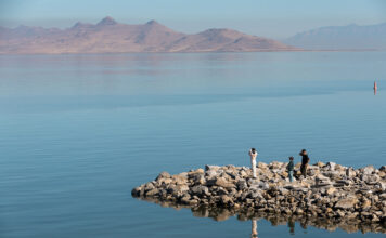 The way to save the Great Salt Lake? Limit new development of all types, poll says Three people standing on a rock inlet near Great Salt Lake