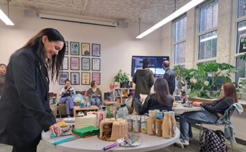 Gender and Sexuality Student Resource Center celebrates four years of operation Event attendee prepares to cut a slice of cake