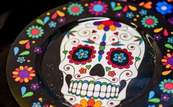 Día de Muertos celebrations at SLCC are about more than just tradition Skull and flowers painted on a black plate