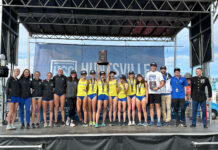 SLCC women’s cross country win two national titles in four days SLCC women's cross country team on stage holding championship