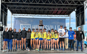 SLCC women’s cross country win two national titles in four days SLCC women's cross country team on stage holding championship