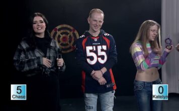 What’s Bruin’ – Ax Throwing Challenge Mavaney Burnham, Chase Eckman and Katelyn MacDuff standing on a game show set