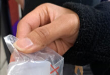 Bruin Pantry offering free menstrual cups while supplies last Person holding a menstrual cup wrapped in plastic, size "XS" for extra small