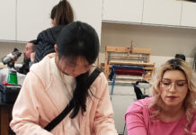 Fashion club hosts crafting event to celebrate Valentine’s Two students working with pink paper to make Valentine's crafts