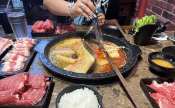 Restaurant review: Hero Hotpot excels in taste and affordability Customer holds utensil over hot pot with two sides