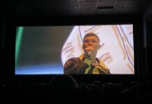 2024 Sundance: ‘Kneecap’ tells the story of modern Ireland A still image of Mo Chara with a microphone during a screening of the film "Kneecap"