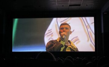 2024 Sundance: ‘Kneecap’ tells the story of modern Ireland A still image of Mo Chara with a microphone during a screening of the film "Kneecap"