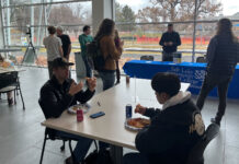 School staff, faculty bring attention to STEM center with ‘(PI)zza’ party Students eating pizza inside the Dumke Center for STEM Learning