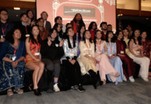 Bruins celebrate Lunar New Year and welcome Year of the Dragon Three rows of people smiling for a group photo during Lunar New Year party