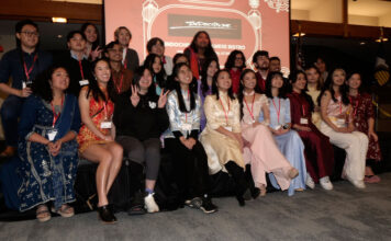 Bruins celebrate Lunar New Year and welcome Year of the Dragon Three rows of people smiling for a group photo during Lunar New Year party