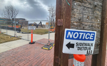 Students can expect a new plaza area at the Redwood campus this fall An orange barricade with "Notice, sidewalk closed" sign next to a construction site