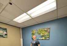 Students can knead the stress away with affordable massage therapy at SLCC Holly standing by a massage table