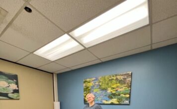 Students can knead the stress away with affordable massage therapy at SLCC Holly standing by a massage table