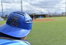 Bruins baseball back in the swing of things as they eye JUCO World Series Salt Lake catcher wearing helmet backward in foreground, baseball field in background