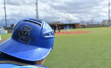 Bruins baseball back in the swing of things as they eye JUCO World Series Salt Lake catcher wearing helmet backward in foreground, baseball field in background