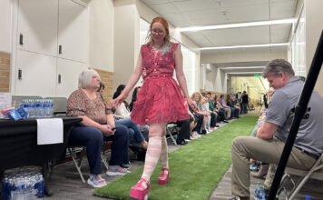 SLCC ‘Trashion Show’ showcases sustainable fashion for Earth Day Model wearing a pink upcycled dress while walking a grass catwalk
