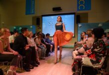 Fashion Institute holds year-end fashion show, announces transfer path with USU Model walking the catwalk while wearing a student's design