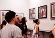 ‘Invisible No More’ photo exhibit commemorates historic march Several people admiring framed photos on display