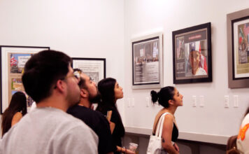 ‘Invisible No More’ photo exhibit commemorates historic march Several people admiring framed photos on display