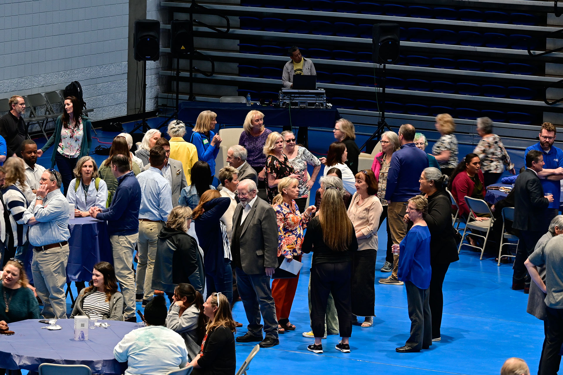 A crowd gathering inside a gymnasium