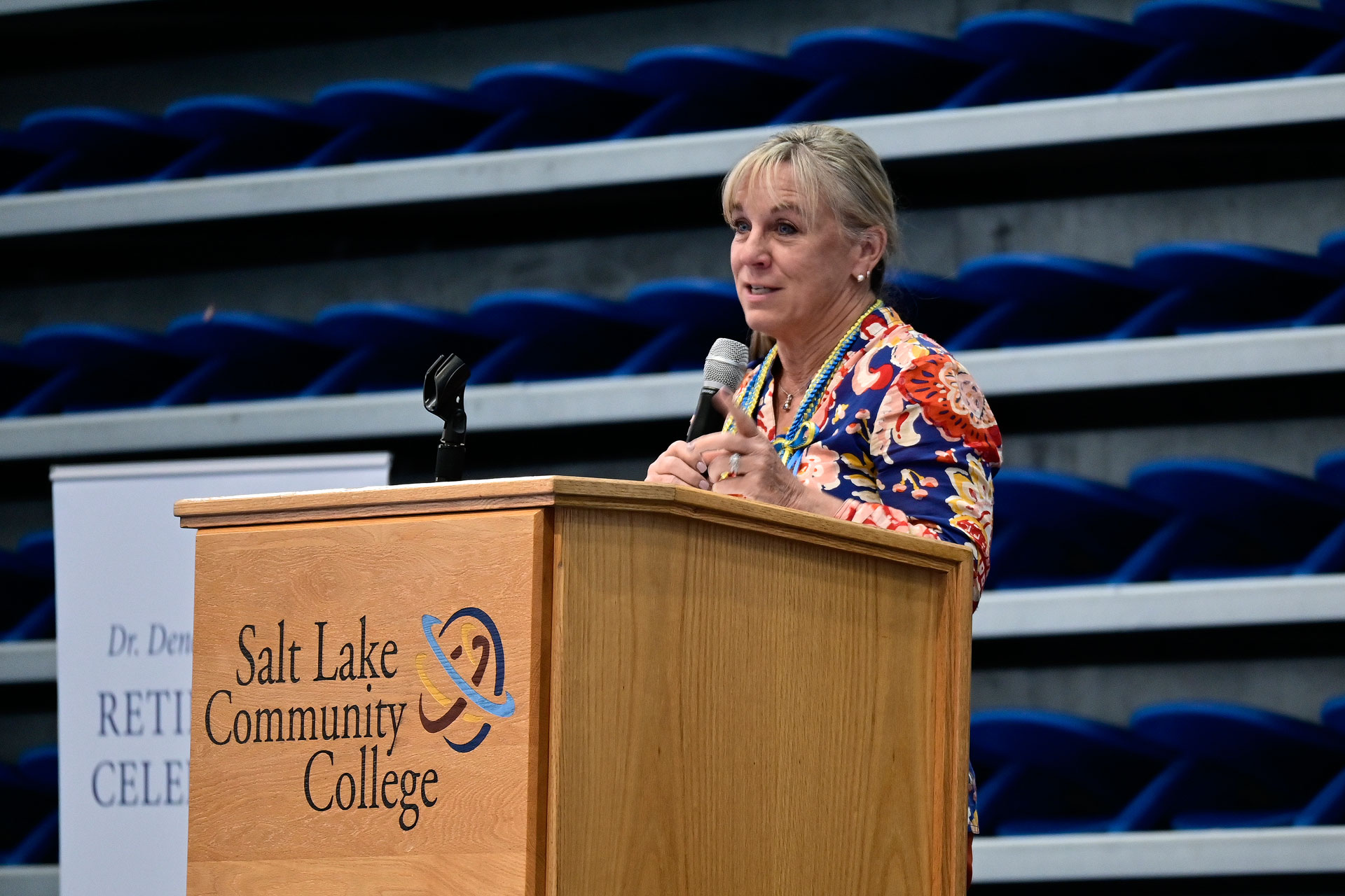 Deneece Huftalin speaking to attendees from behind a podium