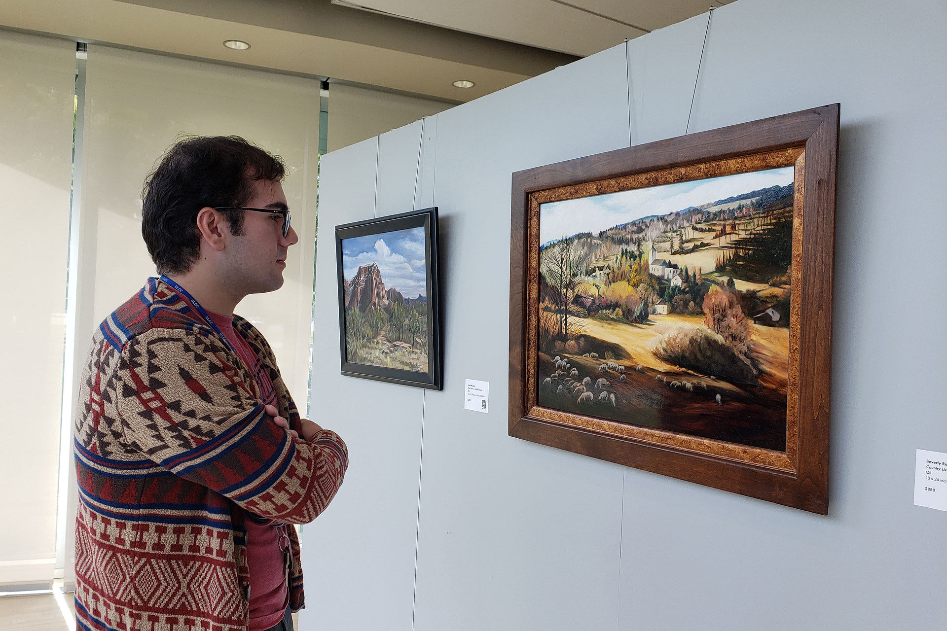 Person viewing a painting in a gallery