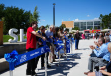 Grand opening of Alder Plaza attracts many students, faculty, and staff, drawing a plethora of positive responses Six people cutting ribbon for Alder Plaza grand opening
