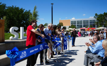 Grand opening of Alder Plaza attracts many students, faculty, and staff, drawing a plethora of positive responses Six people cutting ribbon for Alder Plaza grand opening