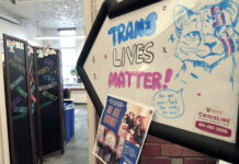 Popular on-campus center to remain open amid anti-DEI bill conversations "Trans Lives Matter" written on arrow-shaped whiteboard sign