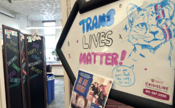 Popular on-campus center to remain open amid anti-DEI bill conversations "Trans Lives Matter" written on arrow-shaped whiteboard sign