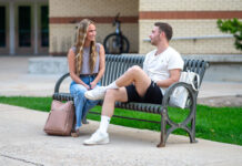 Why are students at Utah State University voting? Two students sitting on a bench and talking