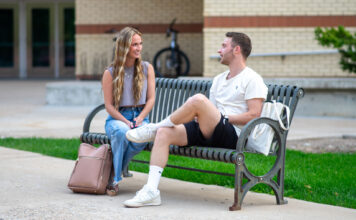 Why are students at Utah State University voting? Two students sitting on a bench and talking
