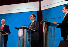 Behind the scenes of Utah’s 2024 gubernatorial debate Spencer Cox, left, Brian King, center, and Robert Latham standing at debate podiums