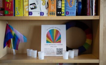 University of Utah faculty, staff, students offer support after HB 261 Candles and LGBTQ-themed decorations on a shelf with a memorial sign for LGBT Resource Center
